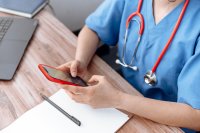 as497418380-Nurse-using-WorkTracker-workshift-appointments-app-at-desk.jpeg