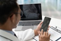 as646319962-doctor-with-mobile-phone-and-laptop.jpeg