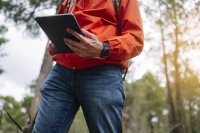 env-nf-man-using-a-tablet-in-the-forest-2025-02-12-18-32-07-utc.jpg